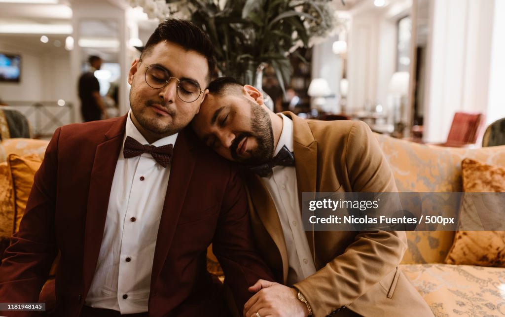 Well dressed male couple in a hotel