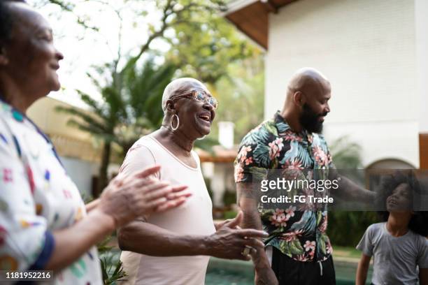 family reunited, singing in backyard - samba dancer imagens e fotografias de stock