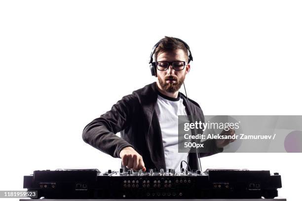 trendy male dj posing against mixing console - dj console stock pictures, royalty-free photos & images