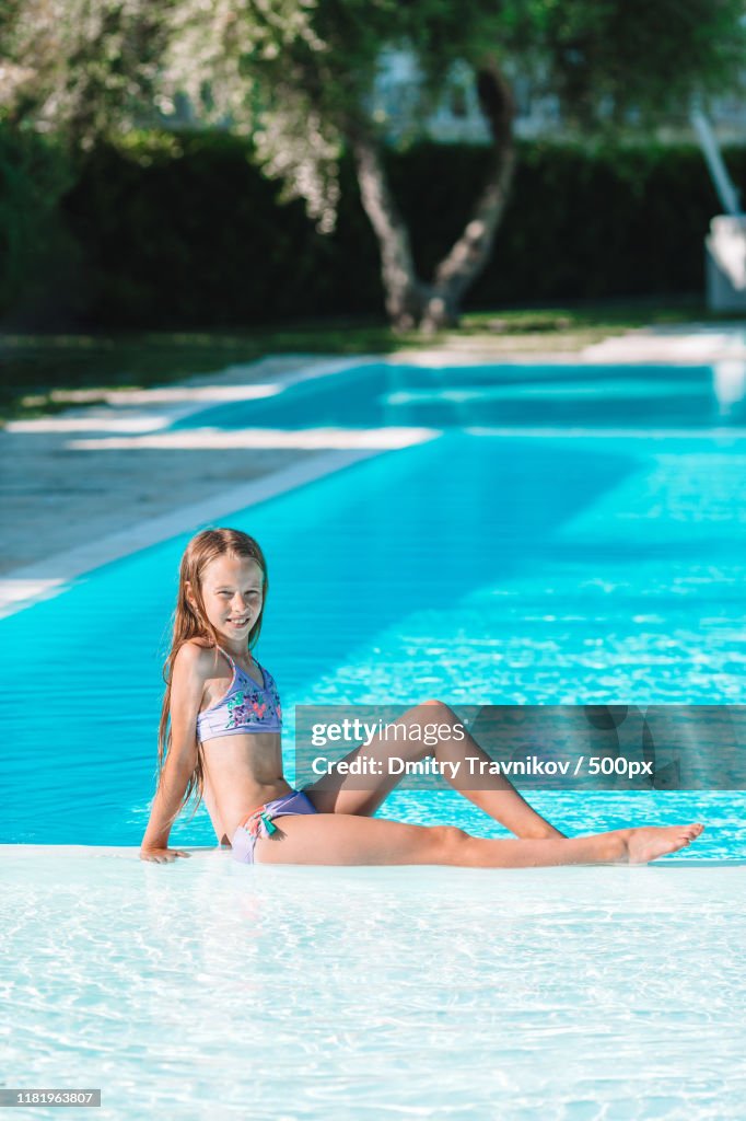 Little Adorable Girl In Outdoor Swimming Pool High-Res Stock Photo