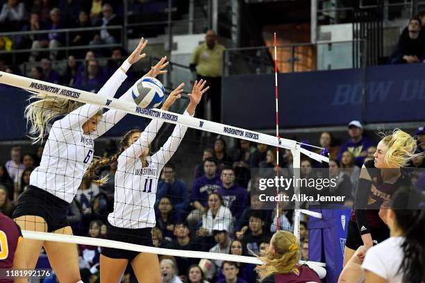 Avie Niece and Shannon Crenshaw of Washington Huskies block Claire Kovensky of the Arizona State Sun Devils during the match at Alaska Airlines Arena...