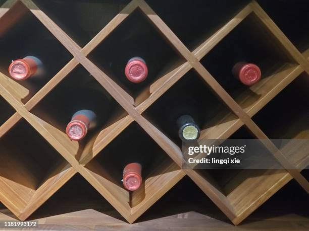 neat red wine on the wine rack - wine rack stock pictures, royalty-free photos & images