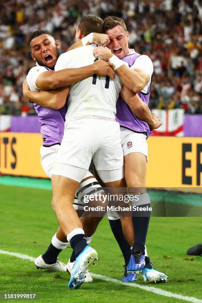 Jonny May of England celebrates with teammates after scoring his team's second try during the Rugby World Cup 2019 Quarter Final match between...