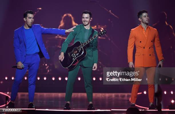 Recording artists Joe Jonas, Kevin Jonas and Nick Jonas of Jonas Brothers perform during a stop of the group's Happiness Begins Tour at MGM Grand...