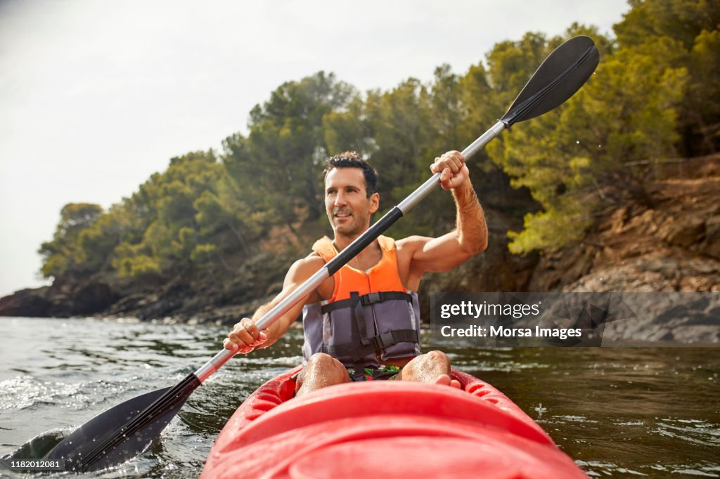 Man kayaking during summer vacation