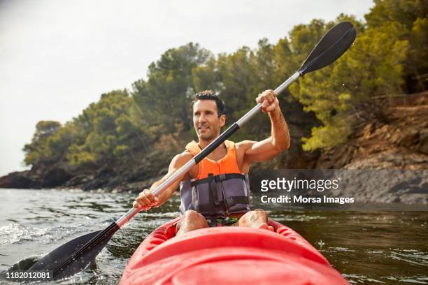 man kayaking during summer vacation - kayaking stock pictures, royalty-free photos & images