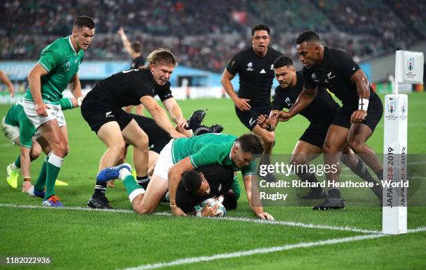 Aaron Smith of New Zealand scores his team's second try past Conor Murray and Jacob Stockdale of Ireland during the Rugby World Cup 2019 Quarter...