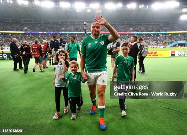 Rory Best of Ireland shows appreciation to the fans as he walks off the pitch with his children following defeat in the Rugby World Cup 2019 Quarter...