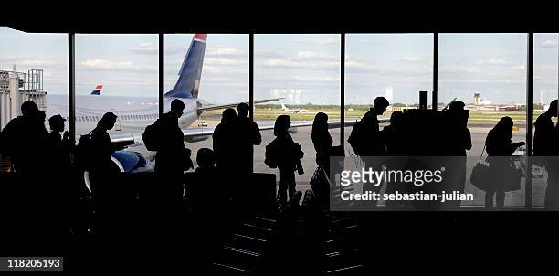 large group of people queuing - silhouette - airport crowd stock pictures, royalty-free photos & images