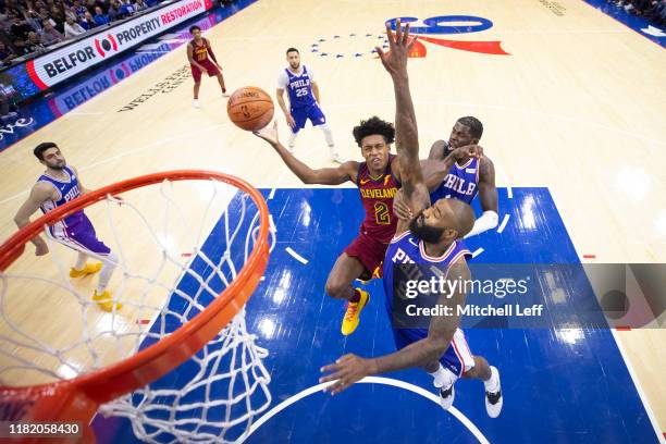 Collin Sexton of the Cleveland Cavaliers goes up for a shot against Kyle O'Quinn and James Ennis III of the Philadelphia 76ers in the second quarter...