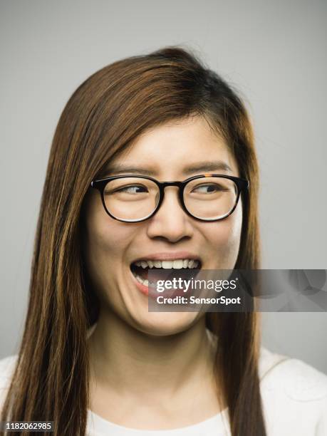real chinese young woman with excited expression looking to the side - looking around stock pictures, royalty-free photos & images