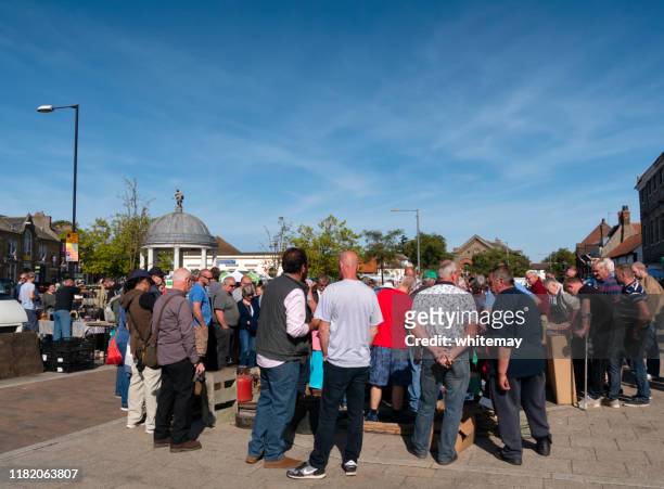 crowd at a street auction in swaffham, norfolk - auction stock pictures, royalty-free photos & images