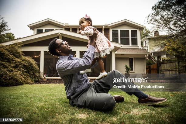 father and daughter (18 months) playing in backyard - sunny backyard stock pictures, royalty-free photos & images