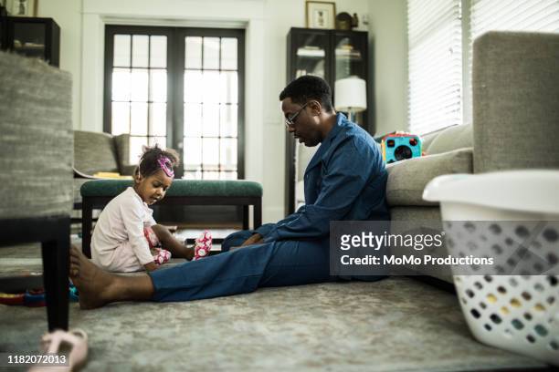 Father and daughter (3 yrs) playing in living room