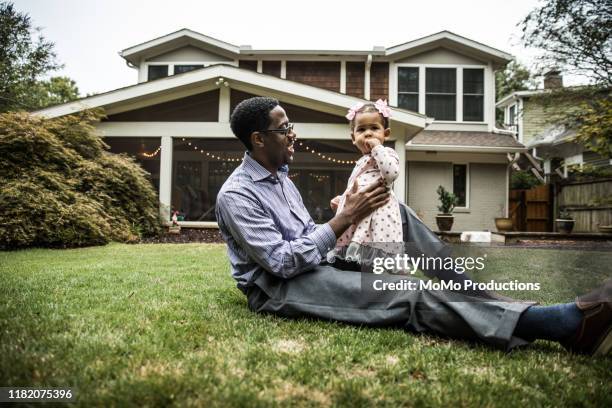 father and daughter (18 months) playing in backyard - family in front of home fotografías e imágenes de stock