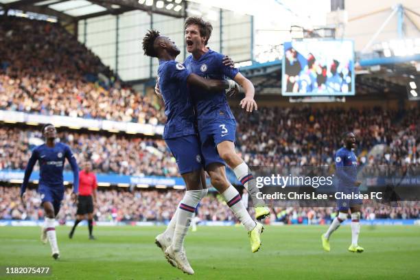 Marcos Alonso of Chelsea celebrates with teammate Tammy Abraham after scoring his team's first goal during the Premier League match between Chelsea...