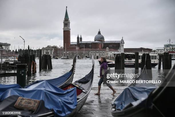 General view shows stranded gondolas washed away at Riva degli Schiavoni, with the San Giorgio Maggiore basilica in background, after an exceptional...