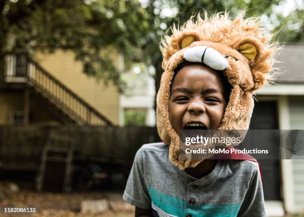 young boy (6 yrs) in lion costume playing in backyard - imagination play stock pictures, royalty-free photos & images