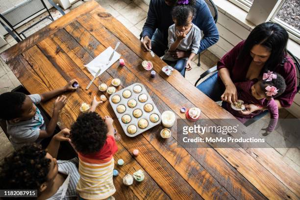 Families making cupcakes at birthday party