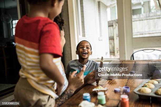 Young boys with cake frosting on faces at party