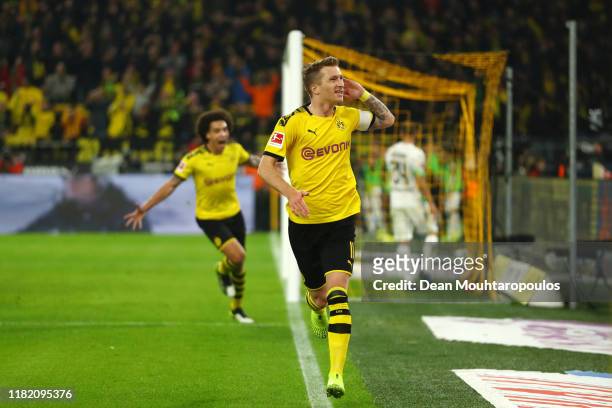 Marco Reus of Borussia Dortmund celebrates after scoring his team's first goal during the Bundesliga match between Borussia Dortmund and Borussia...