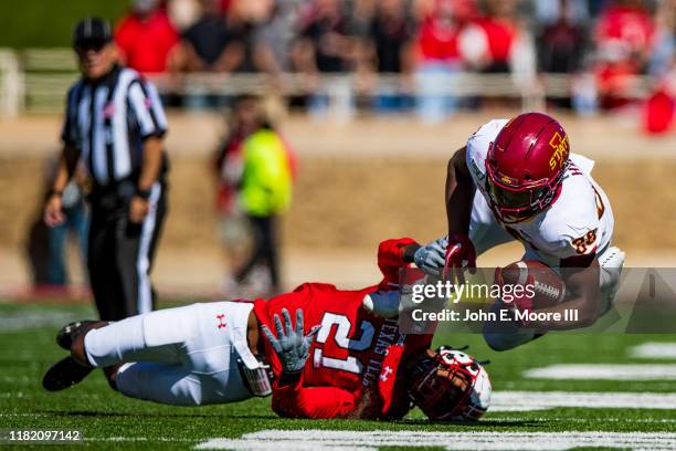 Running back Breece Hall of the Iowa State Cyclones is tackled by linebacker Evan Rambo of the Texas Tech Red Raiders during the first half of the...