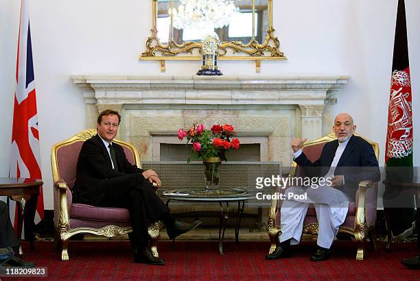 Prime Minister David Cameron attends a press conference with President of Afghanistan, Hamid Karzai, at the presidential palace on July 5, 2011 in...