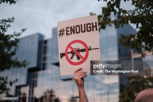 Gun control advocate holds a sign during the Remembrance and Change vigil to honor of the victims of the mass shootings in El Paso, Texas and Dayton,...