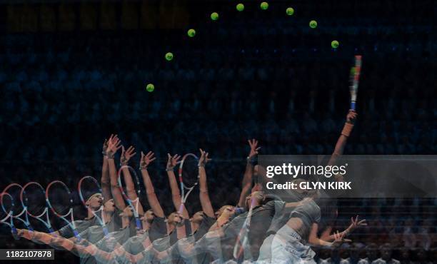 This multi-exposure shows Austria's Dominic Thiem as he serves against Serbia's Novak Djokovic during their men's singles round-robin match on day...