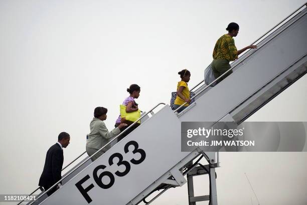 President Barack Obama follows his mother-in-law Marian Robinson , daughters Malia and Sasha , and First Lady Michelle Obama up the ramp to board Air...