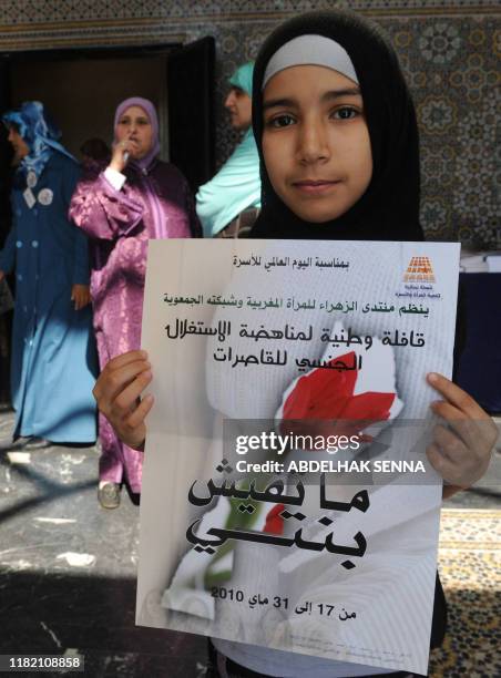 Young girl holds a poster reading "Don't touch my daughter" as part of the opening of the meeting of the feminist organisation "Mountada Azzahrae...