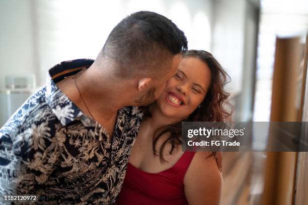 special needs man giving his girlfriend a kiss - couple bonding stock pictures, royalty-free photos & images