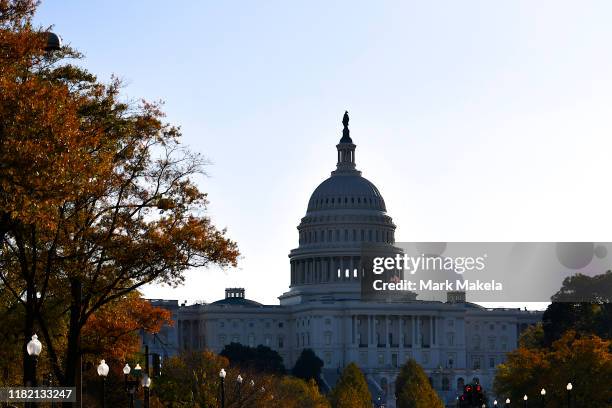 Morning light illuminates an American flag flying at the U.S. Capitol Building on November 13, 2019 in Washington, DC. In the first public...