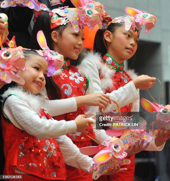 Children dressed as rabbits carry lanterns during a press conference in Taipei on January 17, 2011 to promote this year's lantern festival from...
