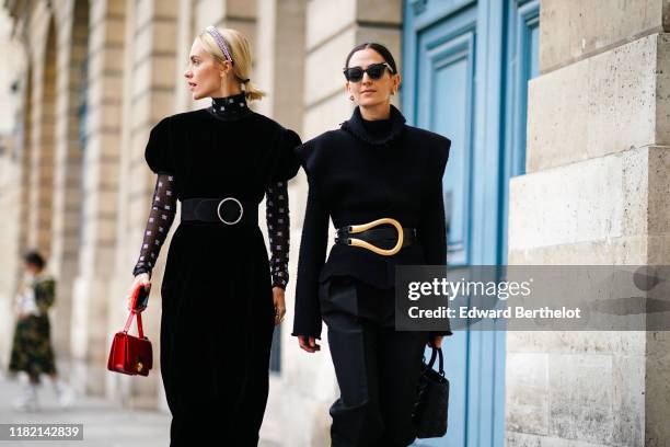 Guest wears a studded headband, a black velvet dress with puff sleeves, a transparent black hi-neck top with white pattern print, a large black belt...