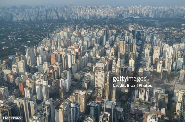 Aerial view of the city of Sao Paulo, Brazil - dense populated neighborhood - Itaim Bibi district in foreground - mixed with green upper-class area...