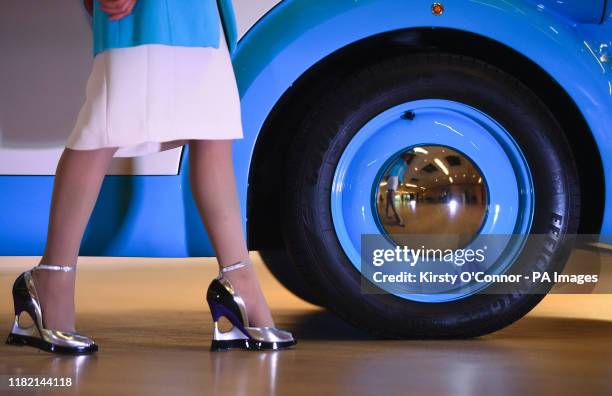 Detail of CEO Qu Li's shoes alongside a wheel of the Morris Commercial JE Type electric van, as it is unveiled at the Design Museum in Kensington,...