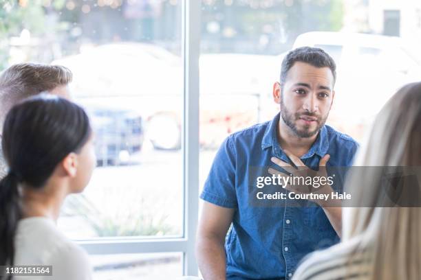 man talking during a support group meeting - mental health services stock pictures, royalty-free photos & images