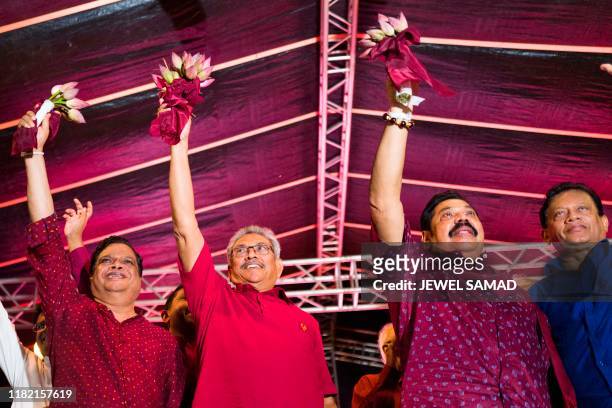 Sri Lanka Podujana Peramuna party presidential candidate Gotabhaya Rajapaksa and his brother, former Sri Lanka's president Mahinda Rajapaksa wave at...