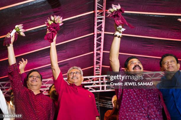 Sri Lanka Podujana Peramuna party presidential candidate Gotabhaya Rajapaksa and his brother, former Sri Lanka's president Mahinda Rajapaksa wave at...