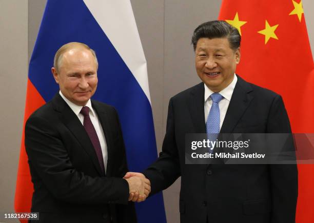 Russian President Vladimir Putin greets Chinese President Xi Jinping during their bilateral meeting on November 13, 2019 in Brasilia, Brazil. The...