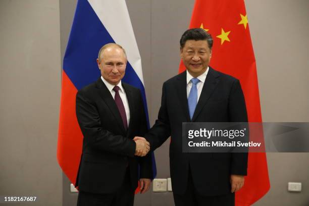 Russian President Vladimir Putin greets Chinese President Xi Jinping during their bilateral meeting on November 13, 2019 in Brasilia, Brazil. The...