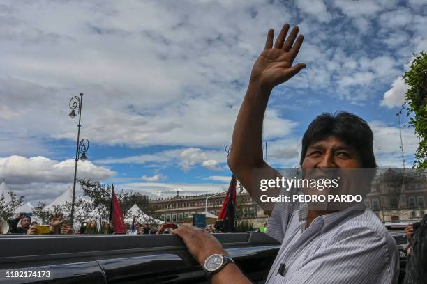 Bolivian ex-President Evo Morales waves as he leaves the Historic City Hall where he was honored as Distinguished Guest by Mexico City's Mayor...