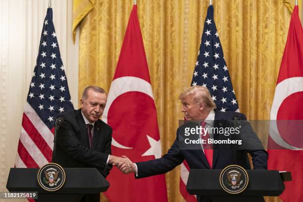 President Donald Trump shakes hands with Recep Tayyip Erdogan, Turkey's president, left, during a joint press conference at the White House in...