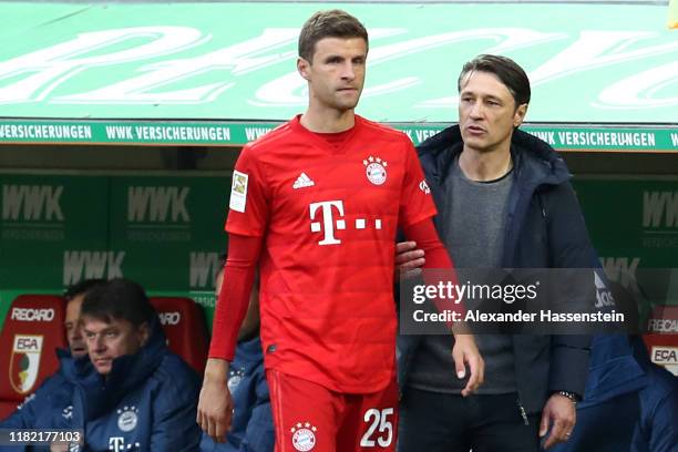 Thomas Mueller of Bayern Muenchen and head coach Niko Kovac during his substitution the Bundesliga match between FC Augsburg and FC Bayern Muenchen...