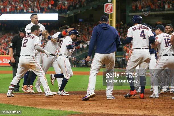 Jose Altuve of the Houston Astros comes home to score after his walk-off two-run home run to win game six of the American League Championship Series...