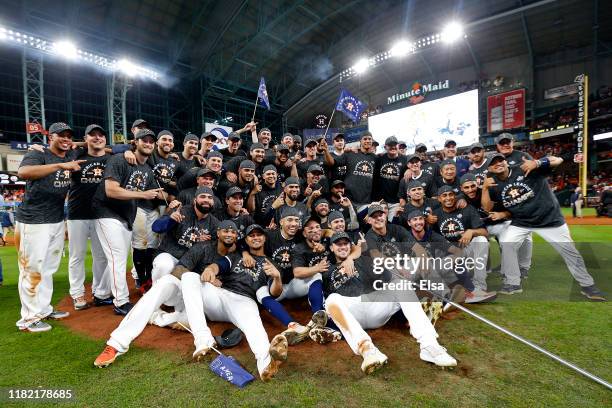 The Houston Astros pose for a photo as they celebrate their 6-4 win against the New York Yankees in game six of the American League Championship...