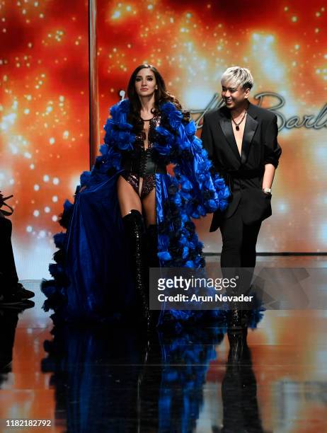 Designer Kenneth Barlis walks the runway with a model during Los Angeles Fashion Week SS/20 Powered by Art Hearts Fashion on October 19, 2019 in Los...