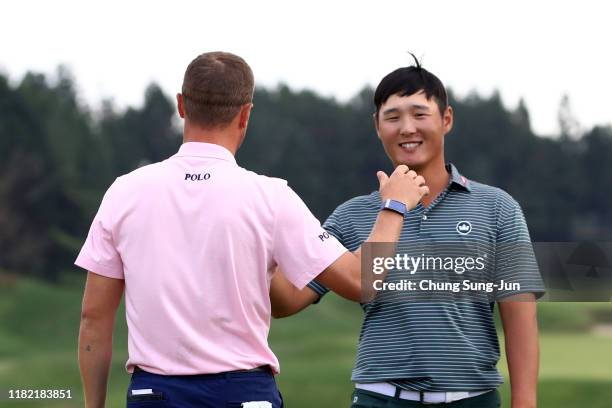 Justin Thomas of the United States is congratulated by Danny Lee of New Zealand after winning the tournament on the 18th green during the final round...