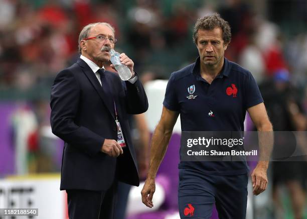 Jacques Brunel, Head Coach of France and Assistant Coach Fabien Galthie look on prior to the Rugby World Cup 2019 Quarter Final match between Wales...